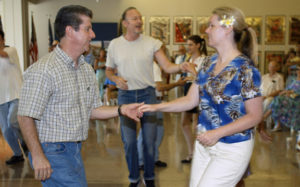 Photo: Leonard Ortiz / Orange County Register - 9/1/03 - - Batch Caption - Photo: Leonard Ortiz / Orange County Register - 9/1/03 - Swing dancers from all over southern California for a swing dance marathon during a Labor Day event at the Richard Nixon Library & Birthplace in Yorba Linda. A free admission day helped attract 1,500 people to the museum. Events also included a performance by the Orange Empire Barbershop Chorus a classic car collection and two new exhibits, a collection of Ronald Reagan movie posters (background) and a Korean War exhibit called"The Coldest War". The Boy Scouts provided hamburgers and hot dogs for the event.